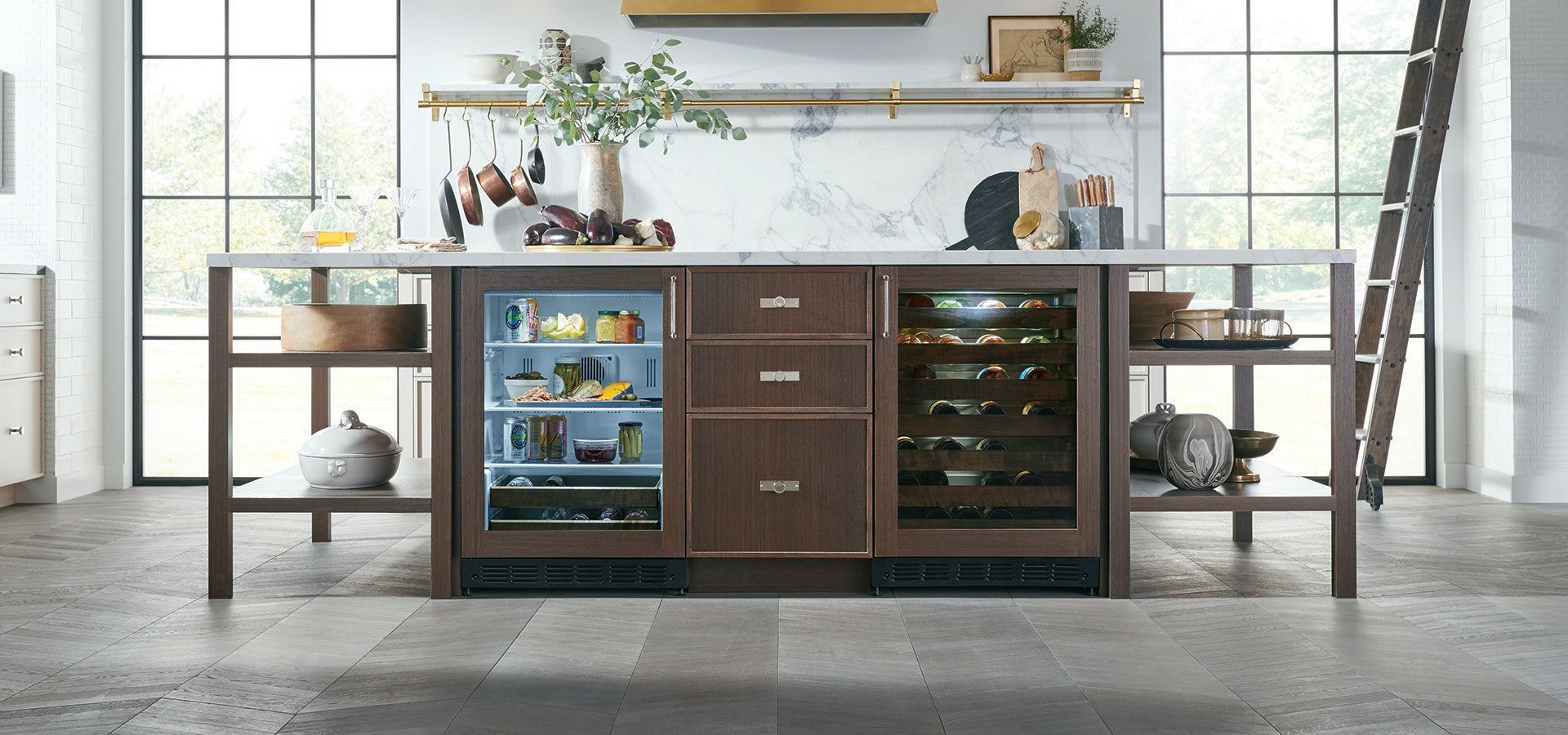 Large kitchen island with built-in wine coolers holding drinks and food