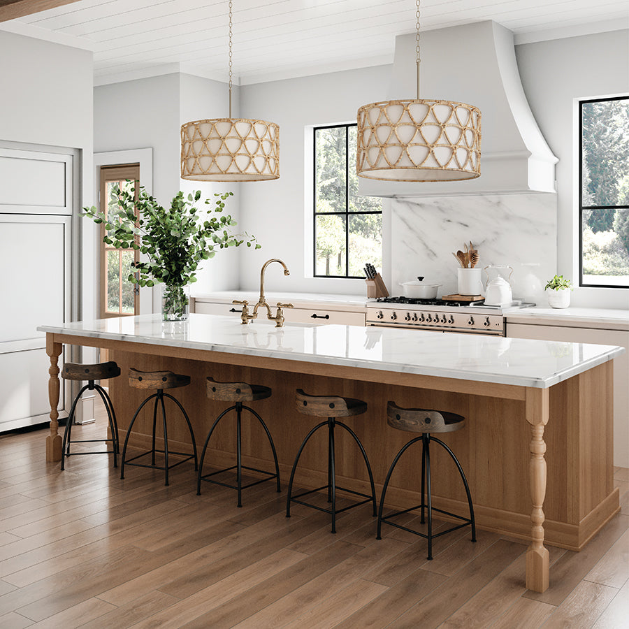 Modern kitchen with a island and stools, featuring a white marble countertop and wooden floor.