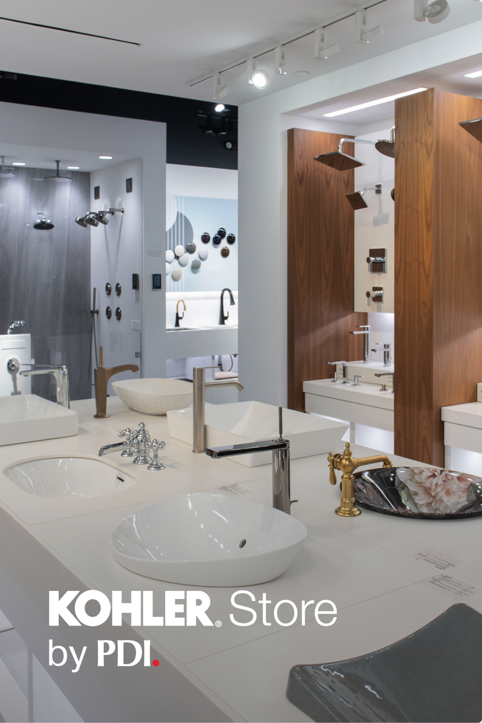 Bathroom showroom with various Kohler fixtures and PDI branding.