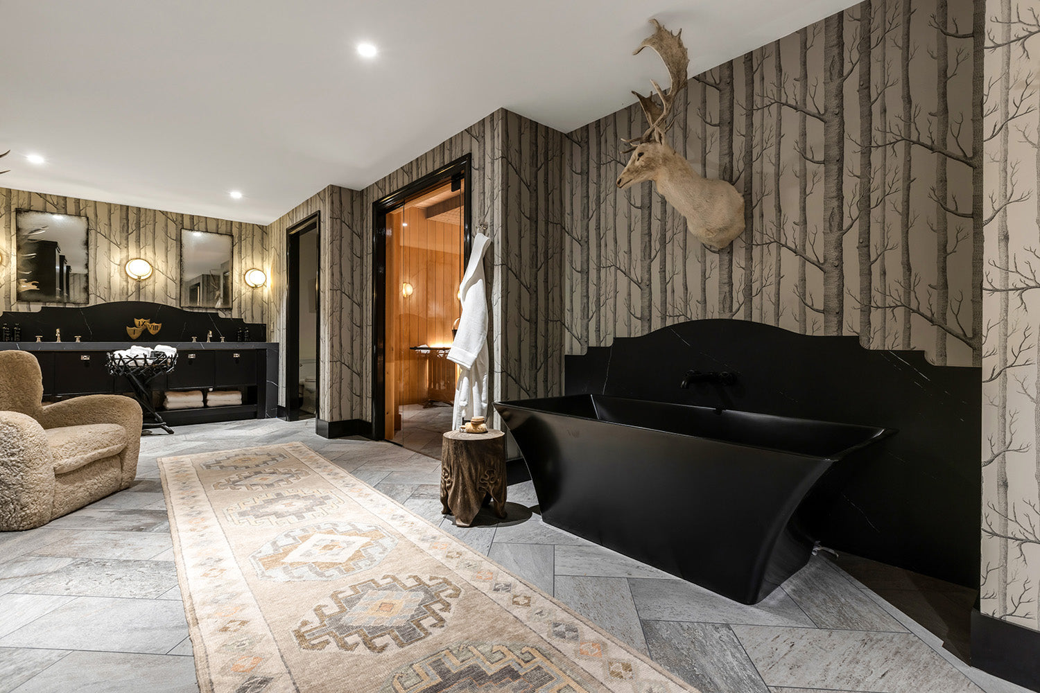 Wellness center with a black cold plunge tub, indoor sauna and large double vanity.